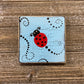 Painted Ladybug Tile on Easel - Blue and Black Dot